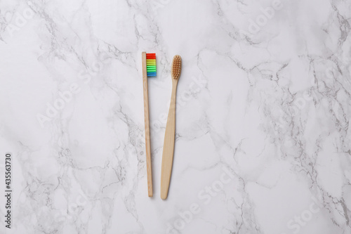 Eco-friendly bamboo toothbrushes on marble surface