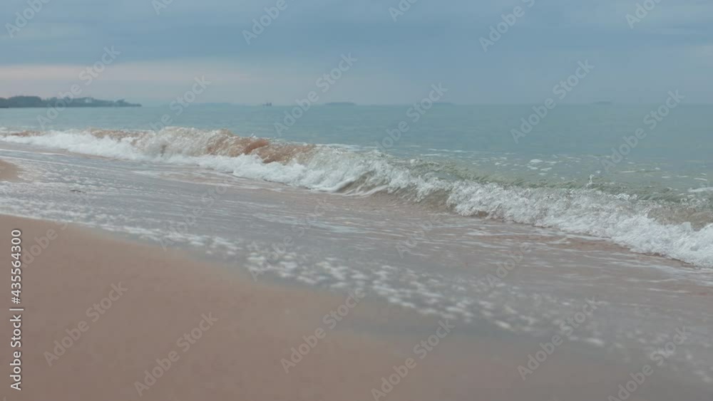 Soft Wave on Sand Beach in Summer Morning. Natural Background. Low Angle View. Static shot and Handheld Soft Wave on Sand Beach in Summer Morning. Natural Background. Low Angle View. Static shot and Handheld