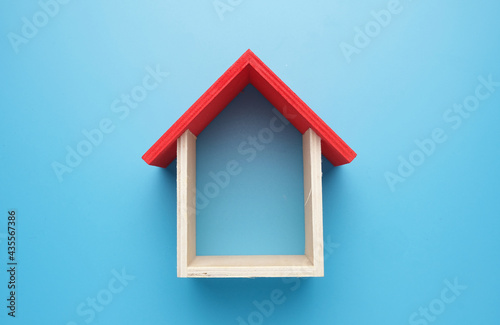 A picture of house miniature on blue background. Property concept, eduction, awareness and investment