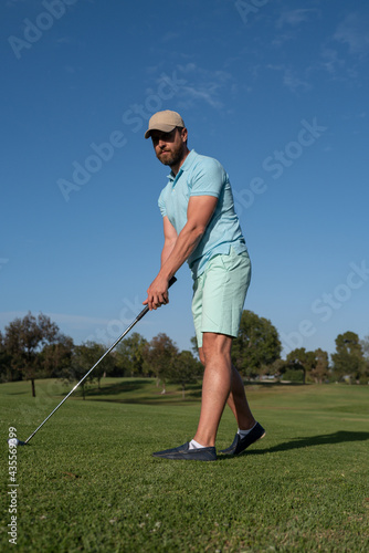 Golfer man playing Golf on beautiful sunny green Golf course.