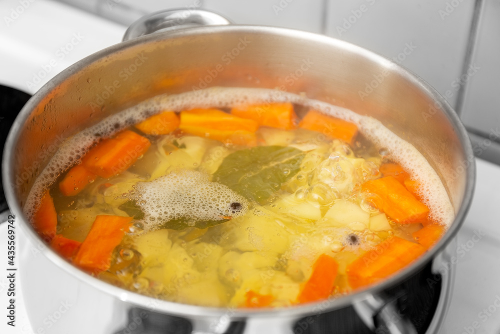 The chef cooks Finnish salmon soup soup is cooked in a saucepan. The chef cooks Finnish salmon soup soup is cooked in a saucepan.