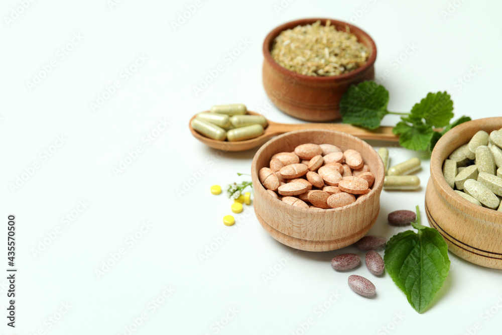 Concept of herbal medicine pills on white background