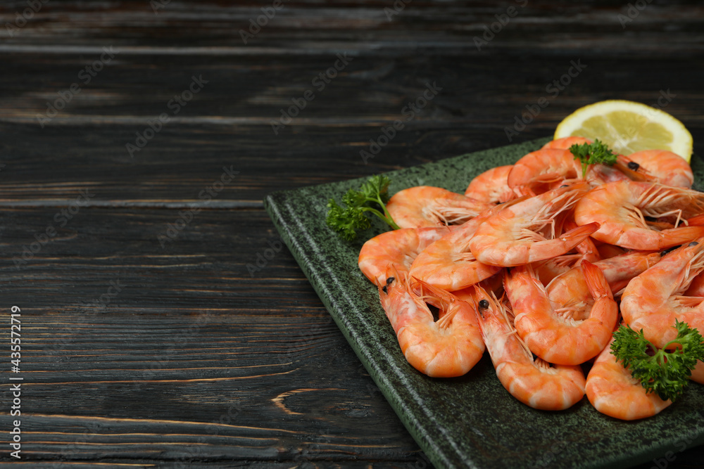 Plate with tasty shrimps on wooden background Plate with tasty shrimps on wooden background