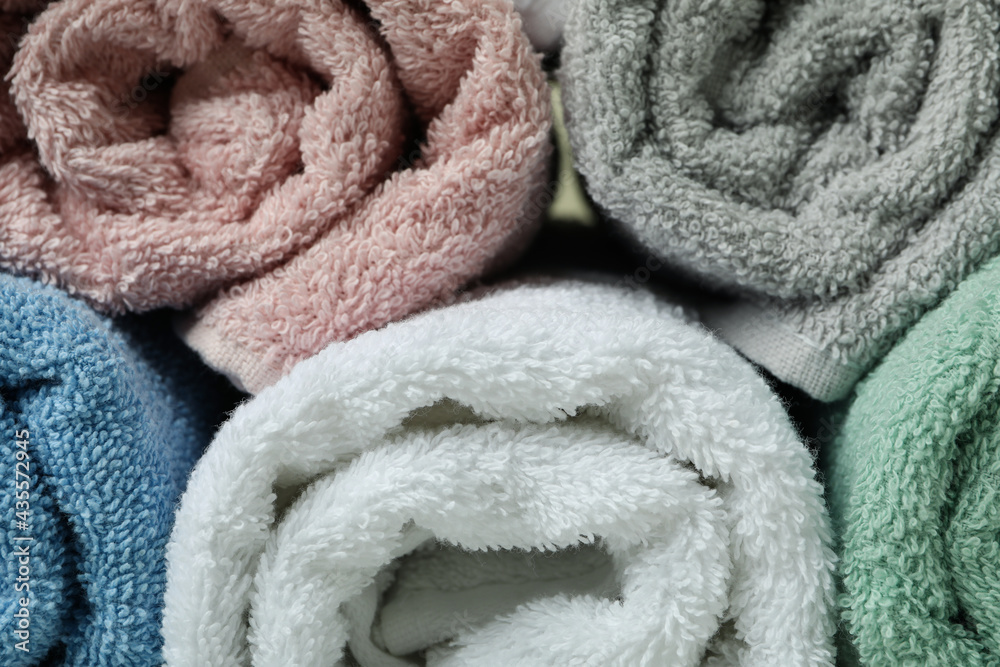 Clean rolled towels on whole background, close up Clean rolled towels on whole background, close up