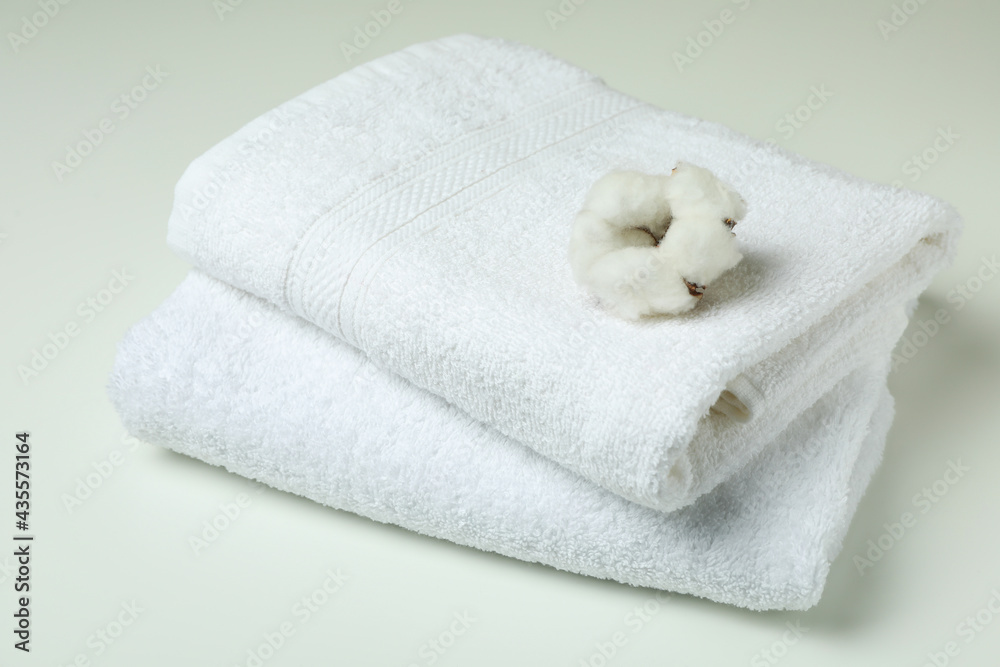 Clean folded towels and cotton on white background Clean folded towels and cotton on white background