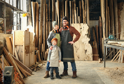 Cheerful parents with kid in craft workshop © JenkoAtaman