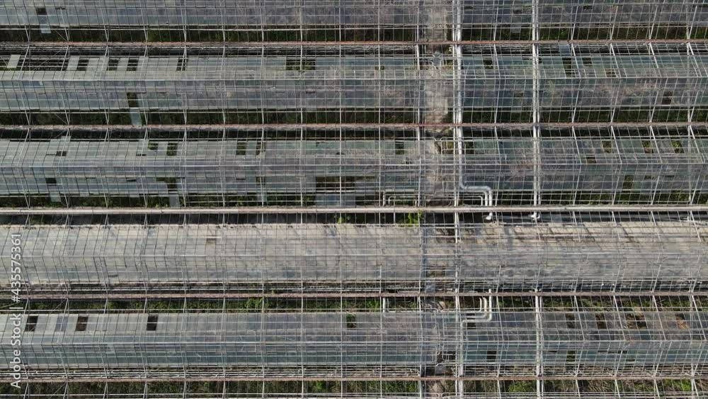 movement of the camera upward from the greenhouses. aerial shooting movement of the camera upward from the greenhouses. aerial shooting
