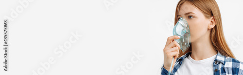 Canvas Print Young woman holding inhalation mask in front of her face, on white background lu