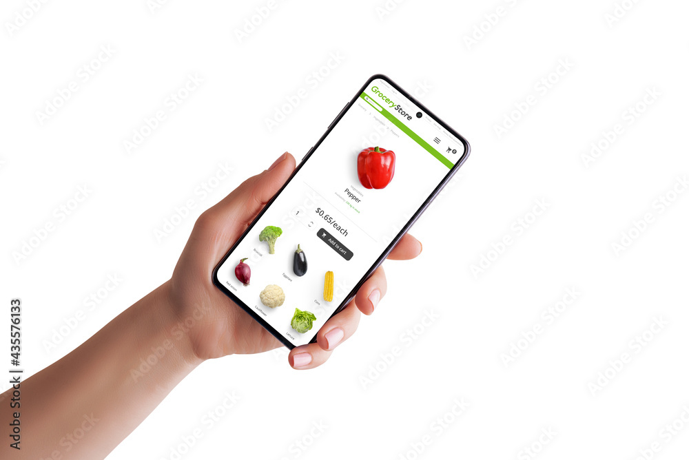 Grocery store web site on mobile phone in woman hand isolated. Modern flat design web site with vegetables and shopping cart Grocery store web site on mobile phone in woman hand isolated. Modern flat design web site with vegetables and shopping cart