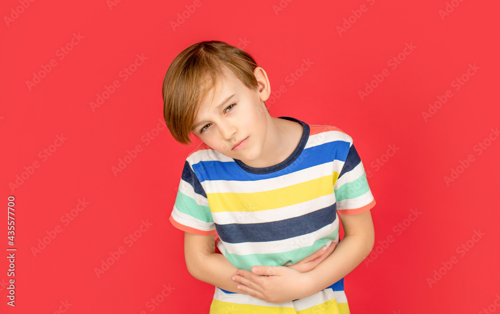 Child has stomachache with food poisoning. Child holding hands on belly. Stomach pain. Teen boy with stomachache. Child having terrible pain in stomach. Diarrhea or gastroenteritis health problem Child has stomachache with food poisoning. Child holding hands on belly. Stomach pain. Teen boy with stomachache. Child having terrible pain in stomach. Diarrhea or gastroenteritis health problem