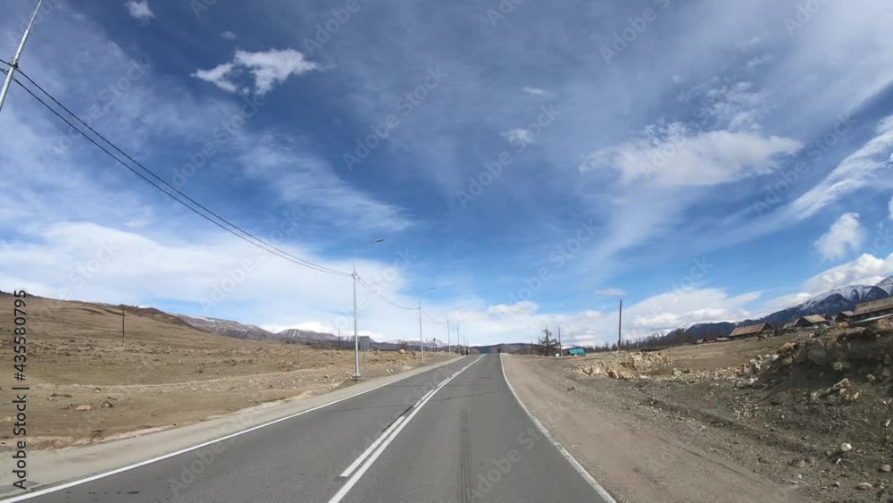 Driving along mountain road on Altai in Kurai intermountain valley Driving along mountain road on Altai in Kurai intermountain valley