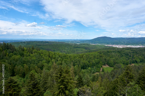 beautiful panarama view from a mountain with forest imposing rocks and under blue sky © creativcontent