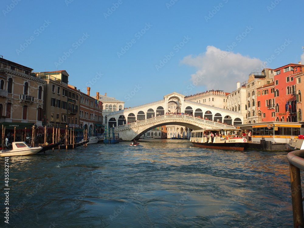The Historic Rialto Bridge Ponte di Rialto above the Famous Canale Grande with a Vaporetto in Italy´s Venice