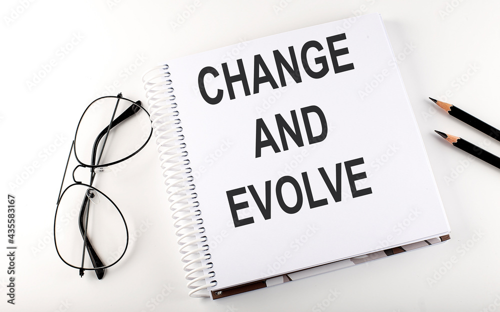 Notebook with text Change and Evolve on white background Notebook with text Change and Evolve on white background