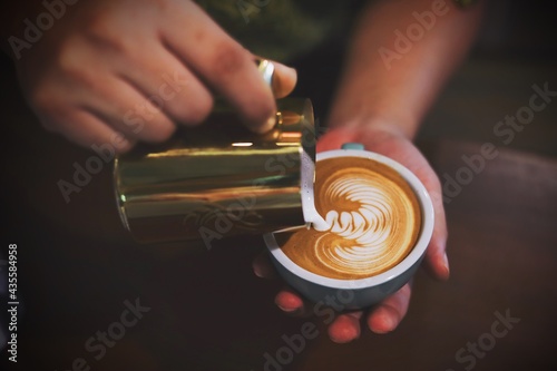 Barista making coffee latte art.
