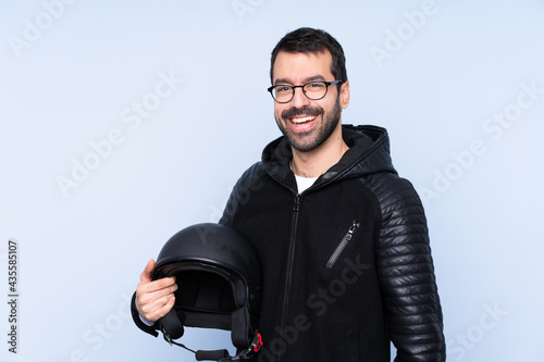Man with a motorcycle helmet over isolated background with glasses and smiling