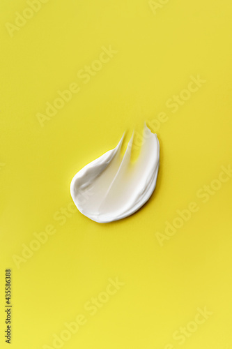 Cream smear on a yellow background.