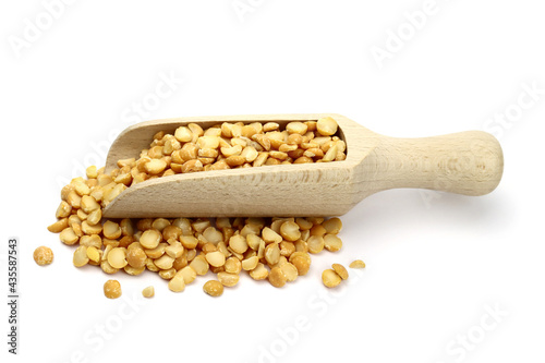 dried peas in wooden scoop isolated on white background