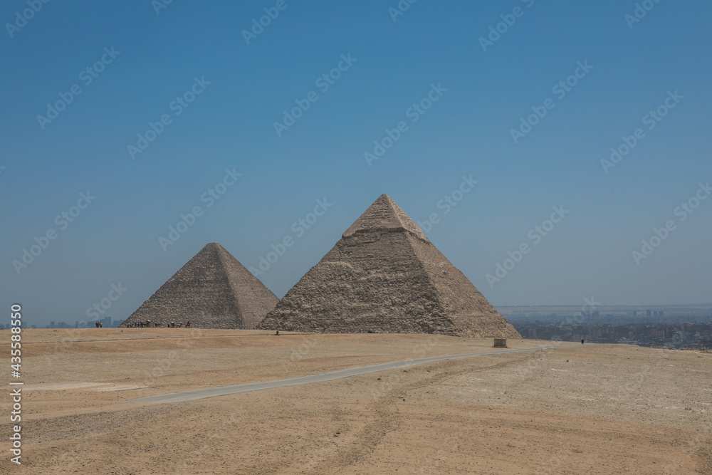 The Great Pyramids of Giza near the ruins of a temple in Giza, Egypt