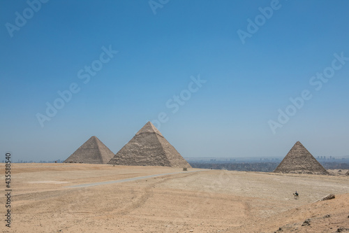 The Great Pyramids of Giza near the ruins of a temple in Giza  Egypt