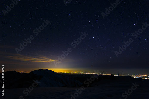 View of the night city from the mountains in winter © Roman