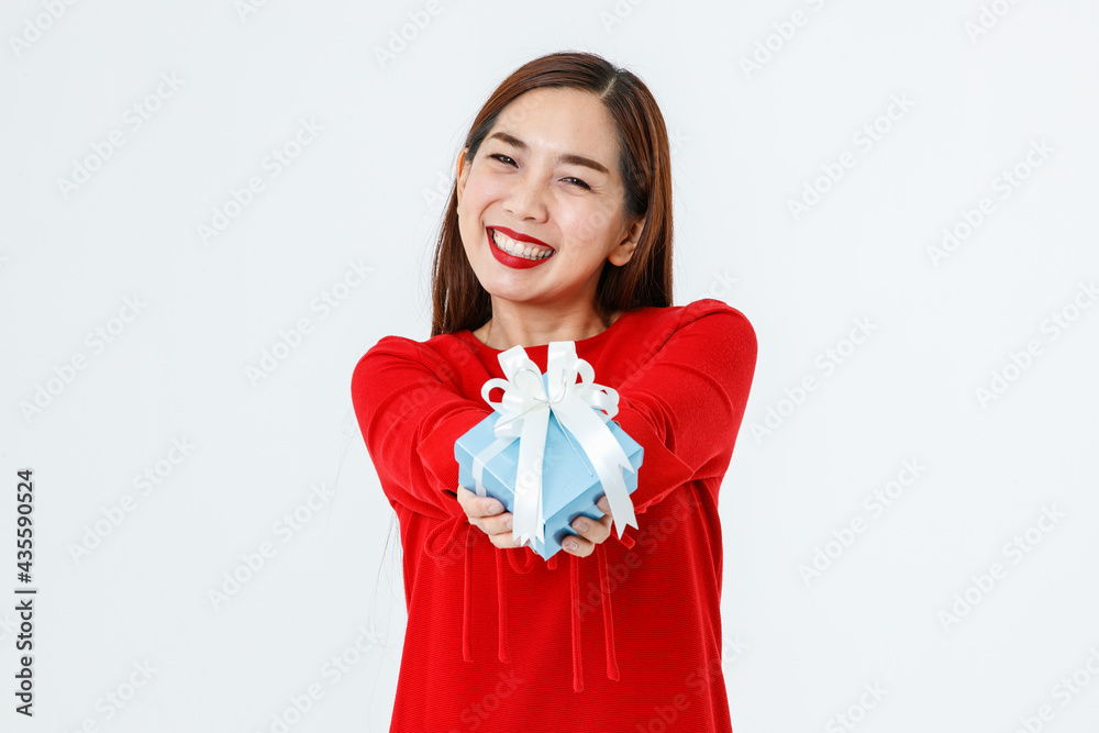 Cheerful ethnic woman with present in studio