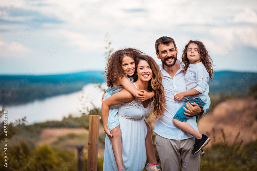Happy family. Portrait of the smiling family standing in the vineyard. Happy family. Portrait of the smiling family standing in the vineyard.