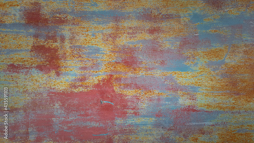 old rusty metal texture with different layers of cracked paint. abstract iron shabby background with copy space