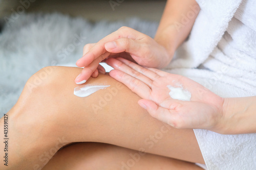 Woman applying legs cream,lotion , Hygiene skin body care concept.