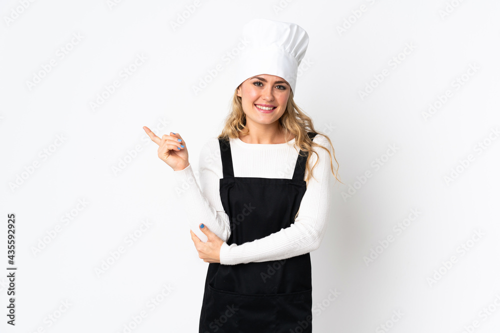 Young Brazilian chef woman isolated on white background pointing finger to the side