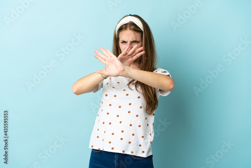 Young caucasian woman over isolated background nervous stretching hands to the front