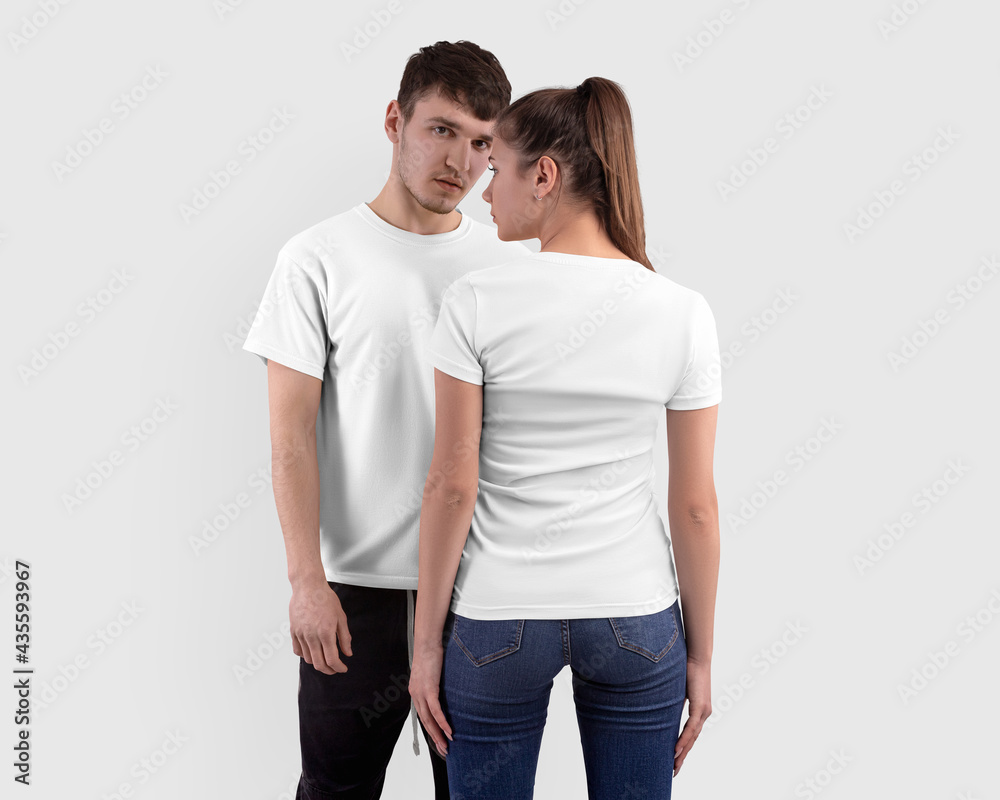 Mockup of a white t-shirt on a girl and a guy, isolated on background in the studio, clothes for design, front, back view Mockup of a white t-shirt on a girl and a guy, isolated on background in the studio, clothes for design, front, back view