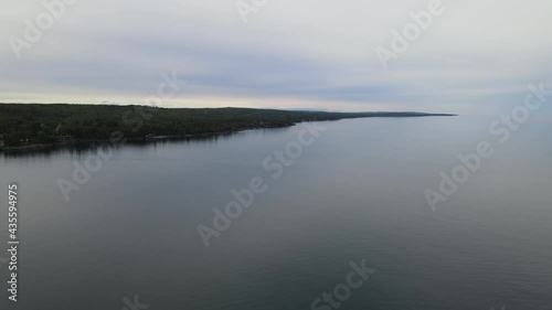 Aerial flyover of Lake Superior showing coastline and vast massive lake. Near Duluth, MN. Cloudy, summer, outdoors.