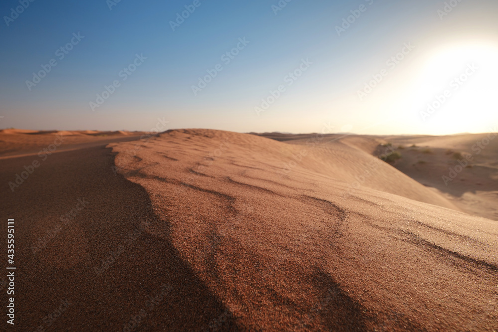 Sunset over the sand dunes in the desert.
