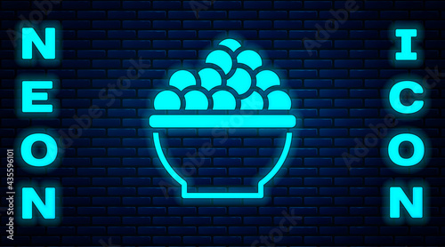 Glowing neon Caviar icon isolated on brick wall background. Vector