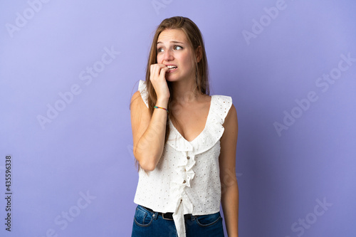 Young caucasian woman over isolated background is a little bit nervous