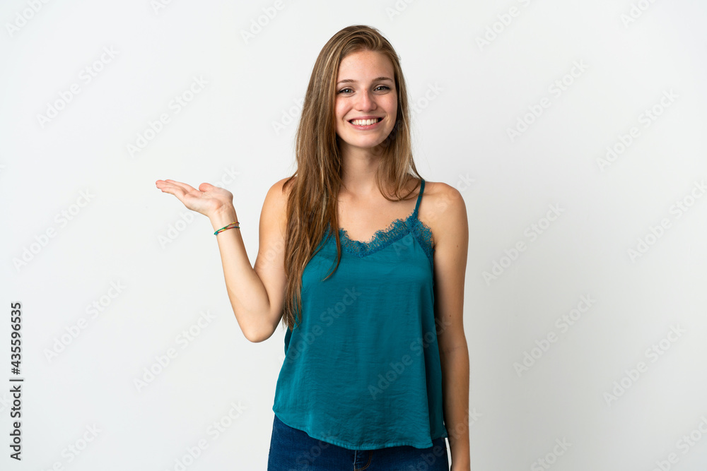 Young caucasian woman over isolated background holding copyspace imaginary on the palm to insert an ad Young caucasian woman over isolated background holding copyspace imaginary on the palm to insert an ad