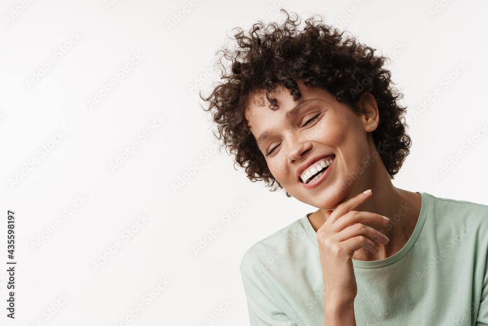 Young curly brunette woman posing and laughing at camera Young curly brunette woman posing and laughing at camera