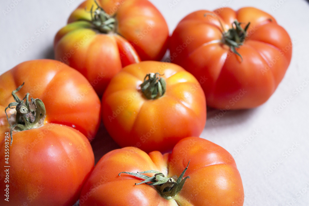 Group of uncooked raw red tomatoes Group of uncooked raw red tomatoes