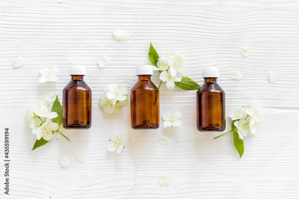 Bottle of fragrant jasmine essential oil. Top view Bottle of fragrant jasmine essential oil. Top view