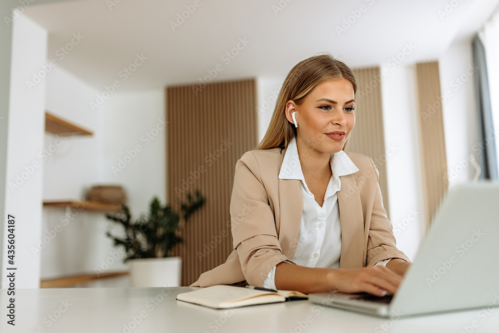 Using laptop, dressed elegant, having online meeting. Using laptop, dressed elegant, having online meeting.