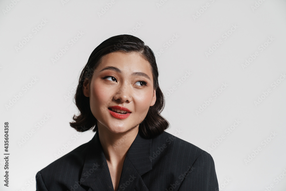 Brunette asian woman wearing jacket posing and looking aside Brunette asian woman wearing jacket posing and looking aside