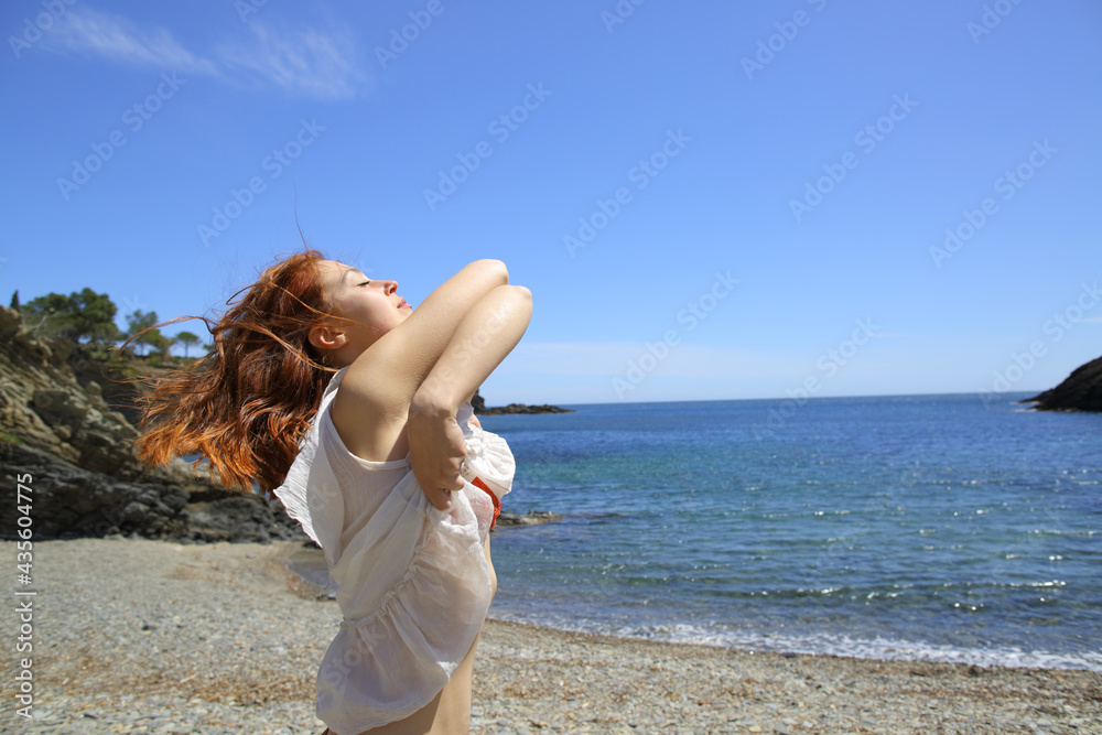 Woman undressing on the beach ready to bath Stock Photo Adobe Stock