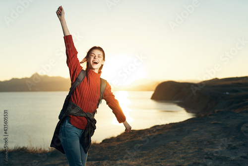 cheerful woman with raised hands travel freedom landscape