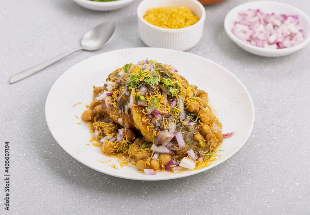 Aloo Tikki or Cutlet or Aloo Patties dipped in Chickpea curry Aloo Tikki or Cutlet or Aloo Patties dipped in Chickpea curry