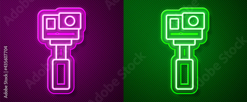 Glowing neon line Action extreme camera icon isolated on purple and green background. Video camera equipment for filming extreme sports. Vector