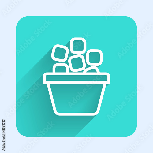 White line Ice bucket filled with ice cubes icon isolated with long shadow. Green square button. Vector