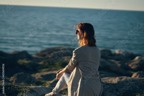 woman by the river in the mountains in nature beach summer landscape fresh air