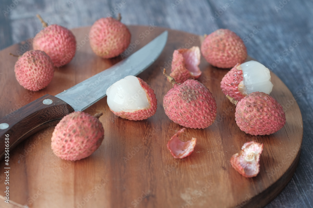 Lychee on a chopping board on table Lychee on a chopping board on table