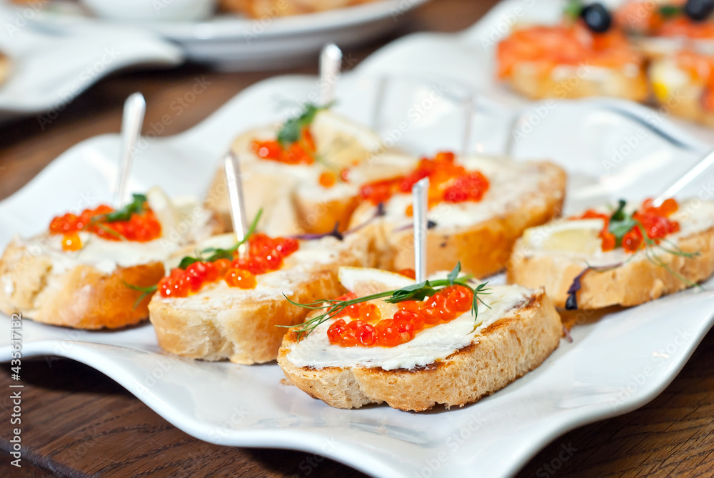Sandwich with caviar and seafood on a white plate. Sandwich with caviar and seafood on a white plate.